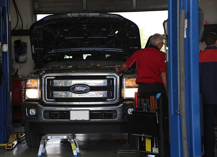 Christian Repairing pick-up truck